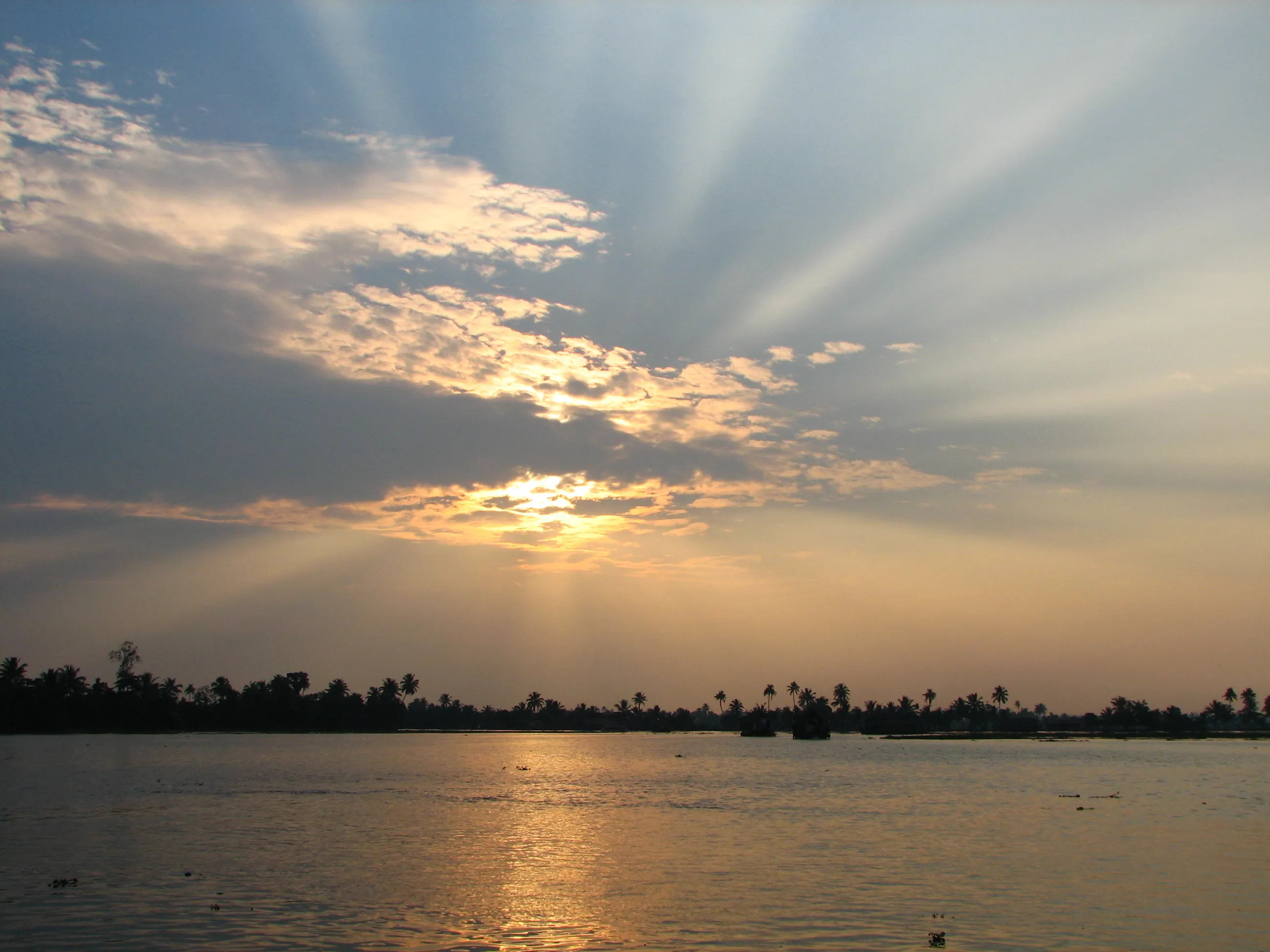 Sun deck of an Alleppey houseboat with lounge seating over the water