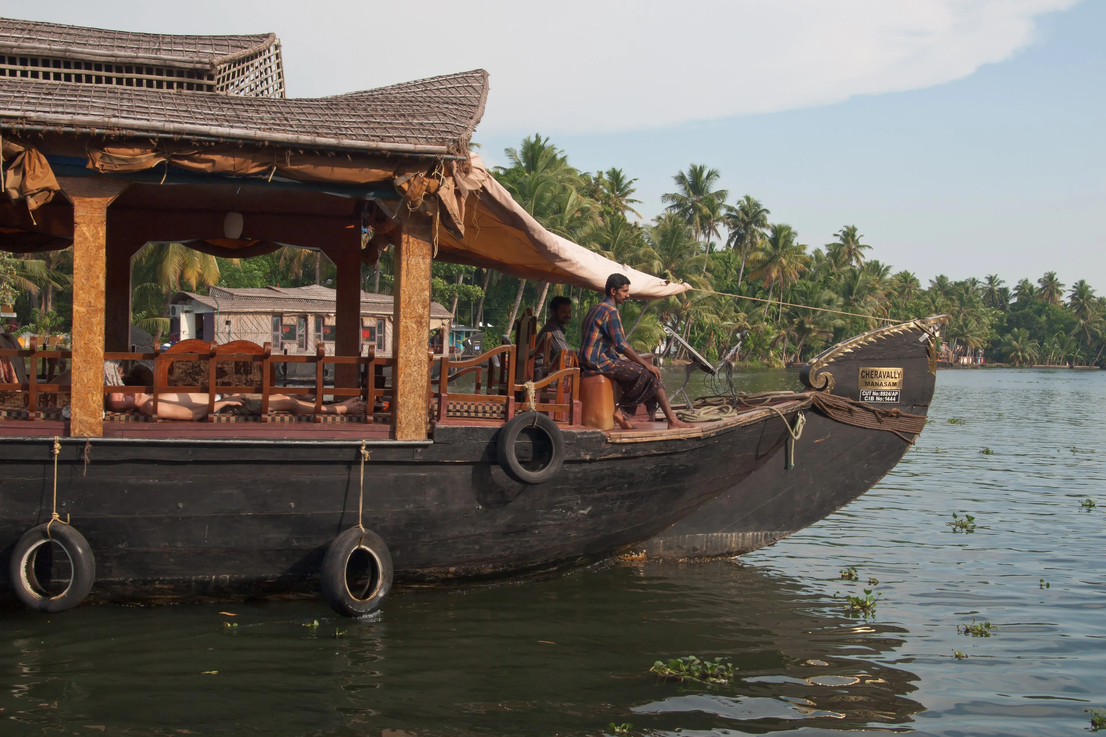 Comfortable air-conditioned bedroom aboard a Kerala houseboat